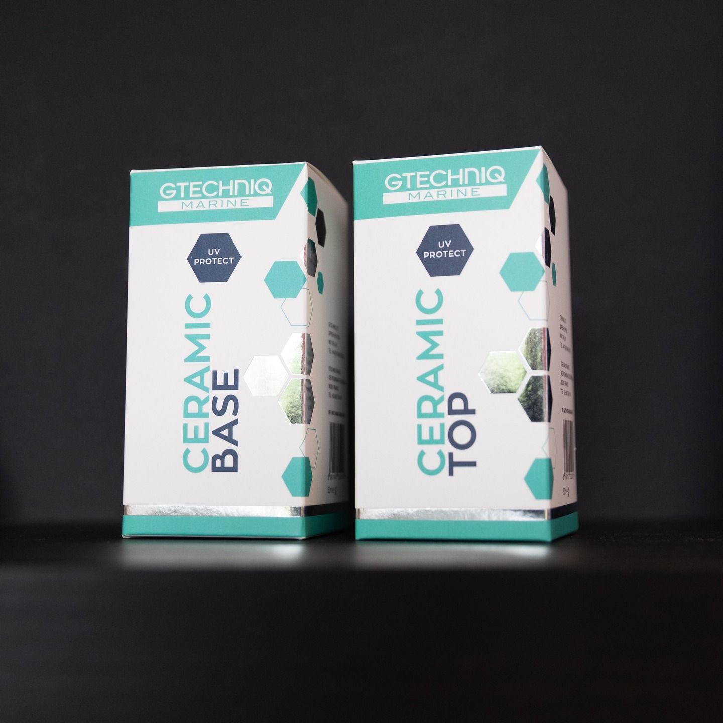 Two GTECHNIQ ceramic coating boxes, one labeled BASE and one TOP, on a dark surface.