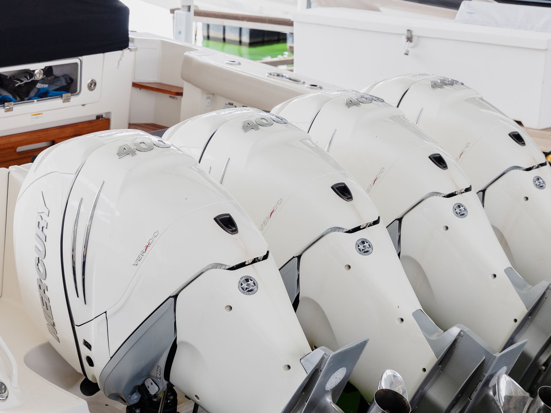 A row of white outboard motors on a boat