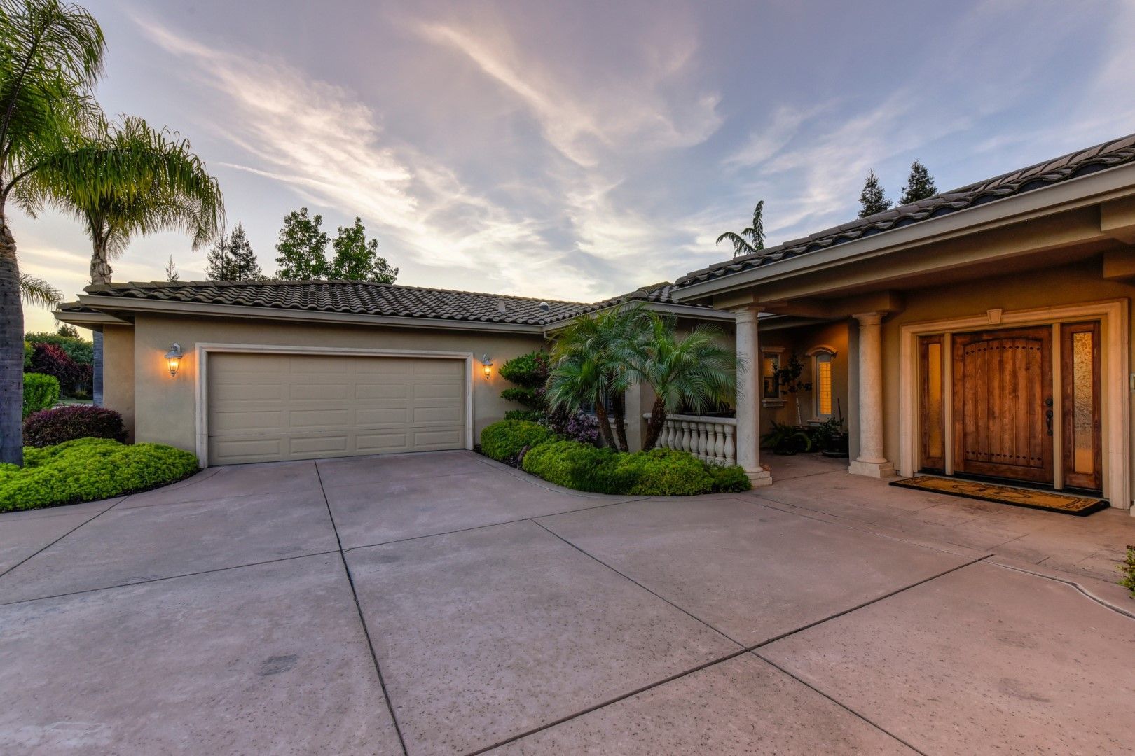 A large house with two garages and a large driveway