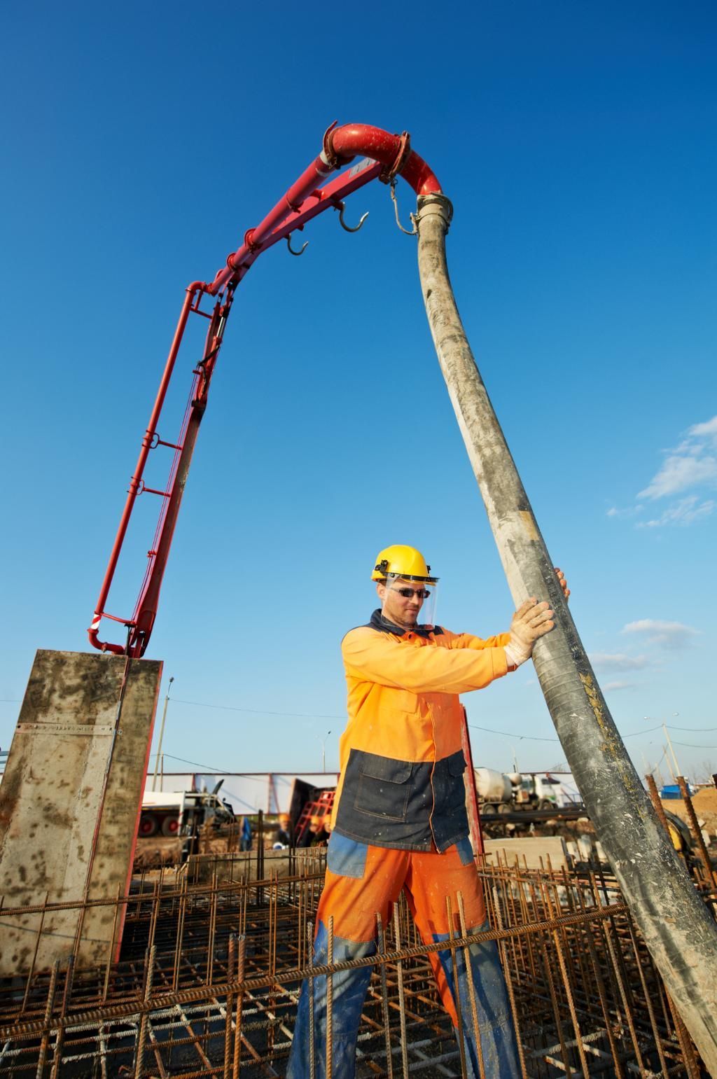 A Construction Worker Is Pumping Concrete — New England & North West Concrete Pumping In Uralla, NSW