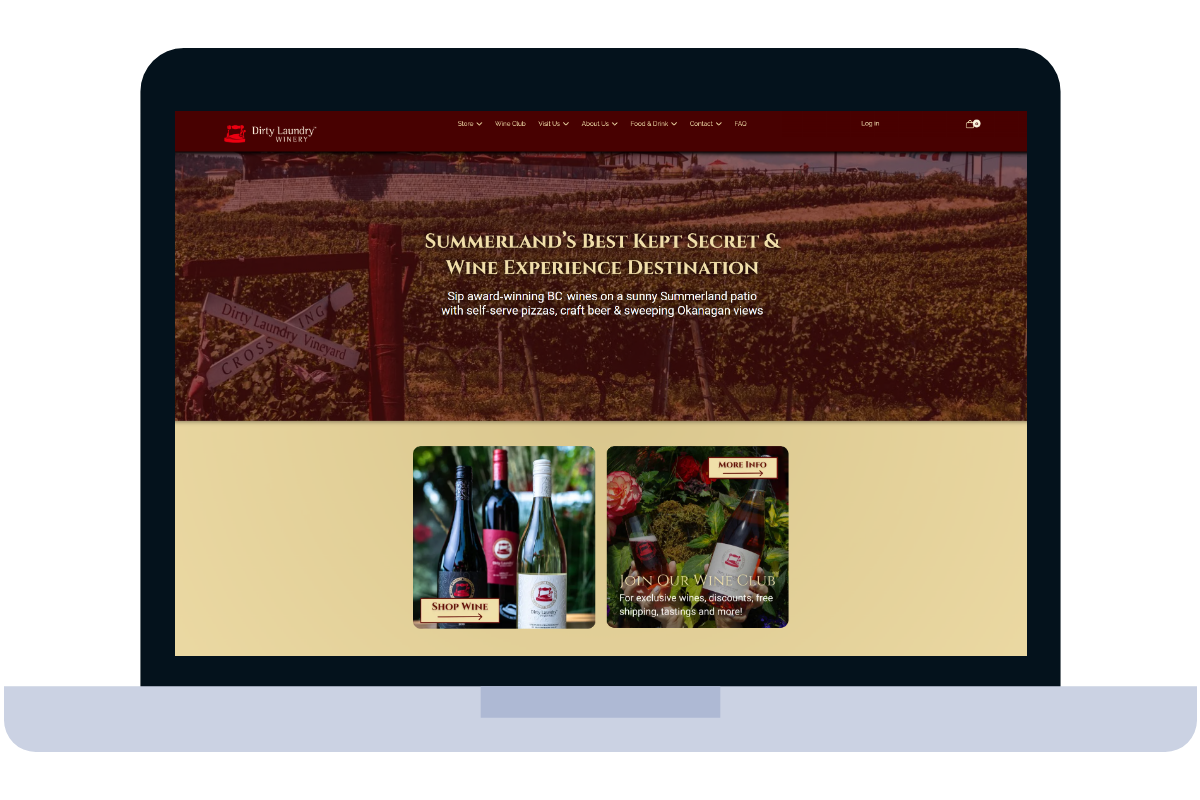 Laptop displaying a winery website with vineyard background and product images.