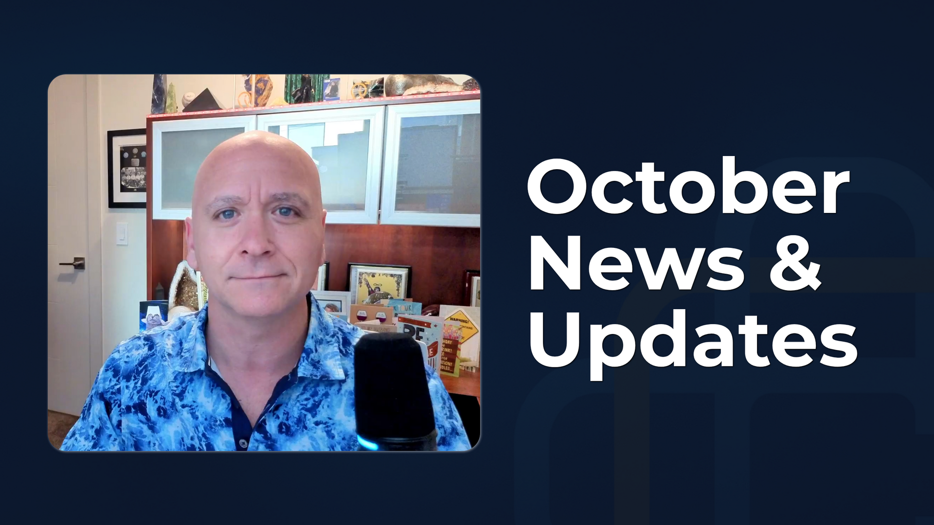 Man seated in a home office beside a microphone, with “October News & Updates” text on a dark blue background