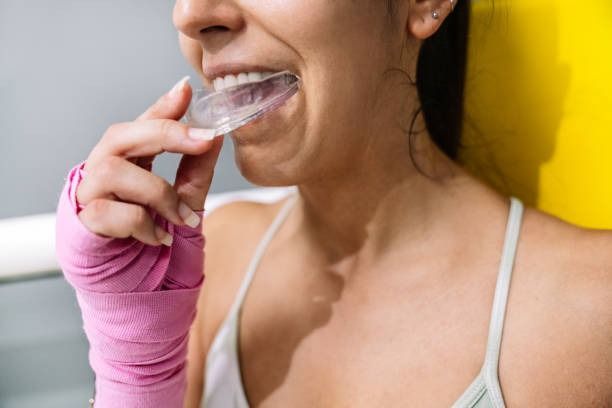 Patient inserting a sports mouthguard at Robert A. Lantzy DMD, Sports Mouthguards in Newtown, PA