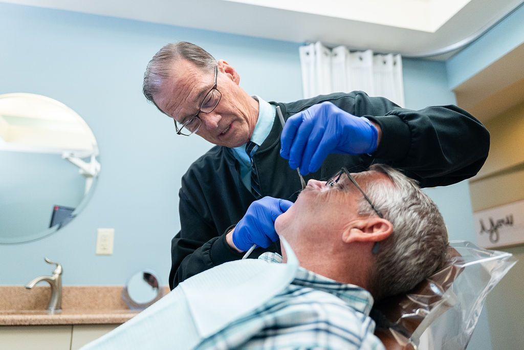 Dr. Robert Lantzy examining a patient at Robert A. Lantzy DMD, Complete Health Dentistry in Newtown, PA