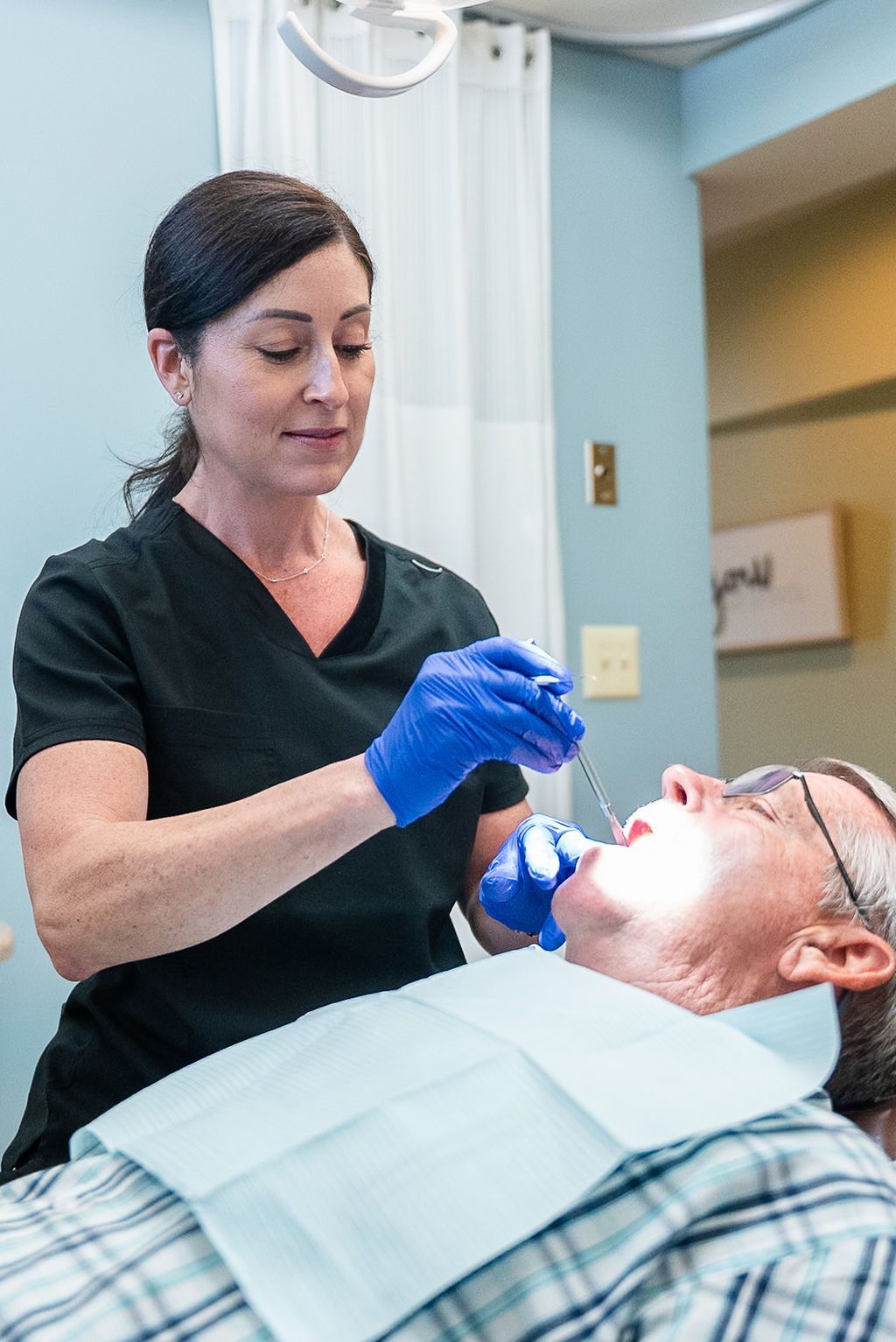 Dentist evaluating a patient's oral health at Robert A. Lantzy DMD, Oral-Systemic Health in Newtown, PA