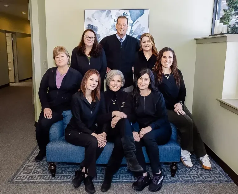 Seven people posing on a blue couch at Robert A. Lantzy, DMD, LCC in Newtown, PA