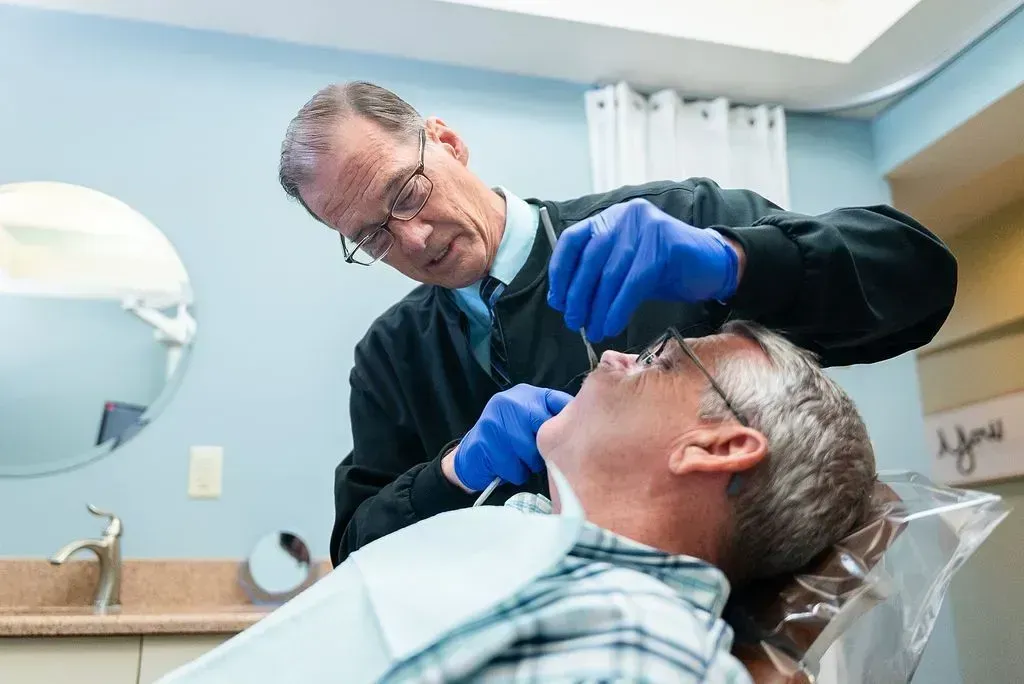 Dr. Robert Lantzy examining a patient at Robert A. Lantzy DMD, Complete Health Dentistry in Newtown, PA