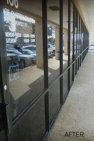 A hallway with a lot of windows and a sign that says `` open ''.