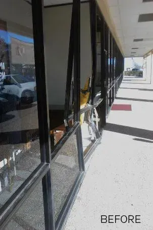 A before picture of a building with broken windows.