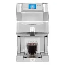 Silver coffee machine dispensing dark liquid into a glass mug.