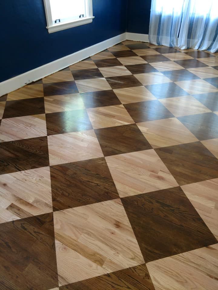 Checkered hardwood floor in brown and light wood tones.