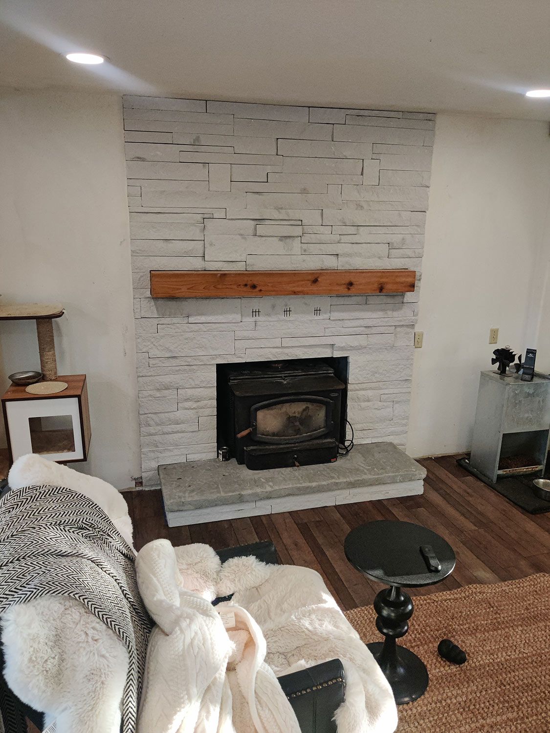 A living room featuring a stone fireplace