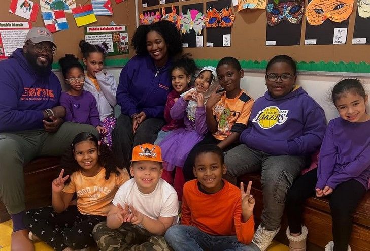 A group of children are posing for a picture in a classroom.