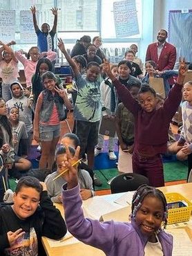 A group of children are posing for a picture in a classroom.