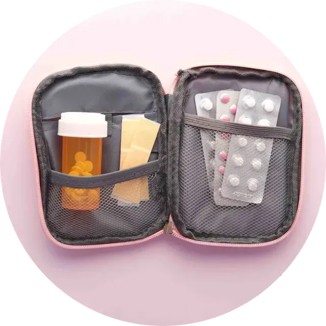 Open pill case with prescription bottle and blister packs on a pink background