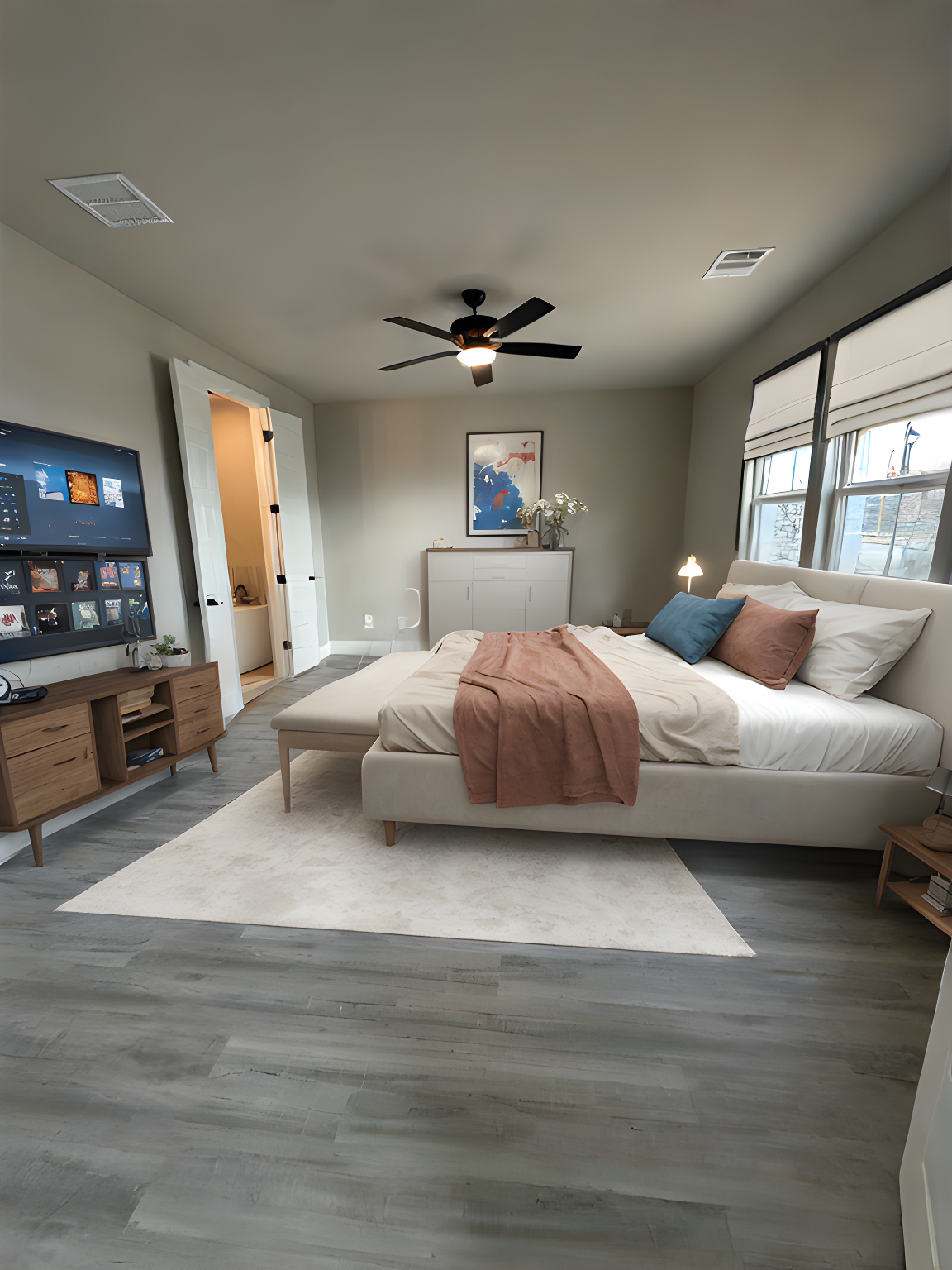 A bedroom with a large bed , television , and ceiling fan.
