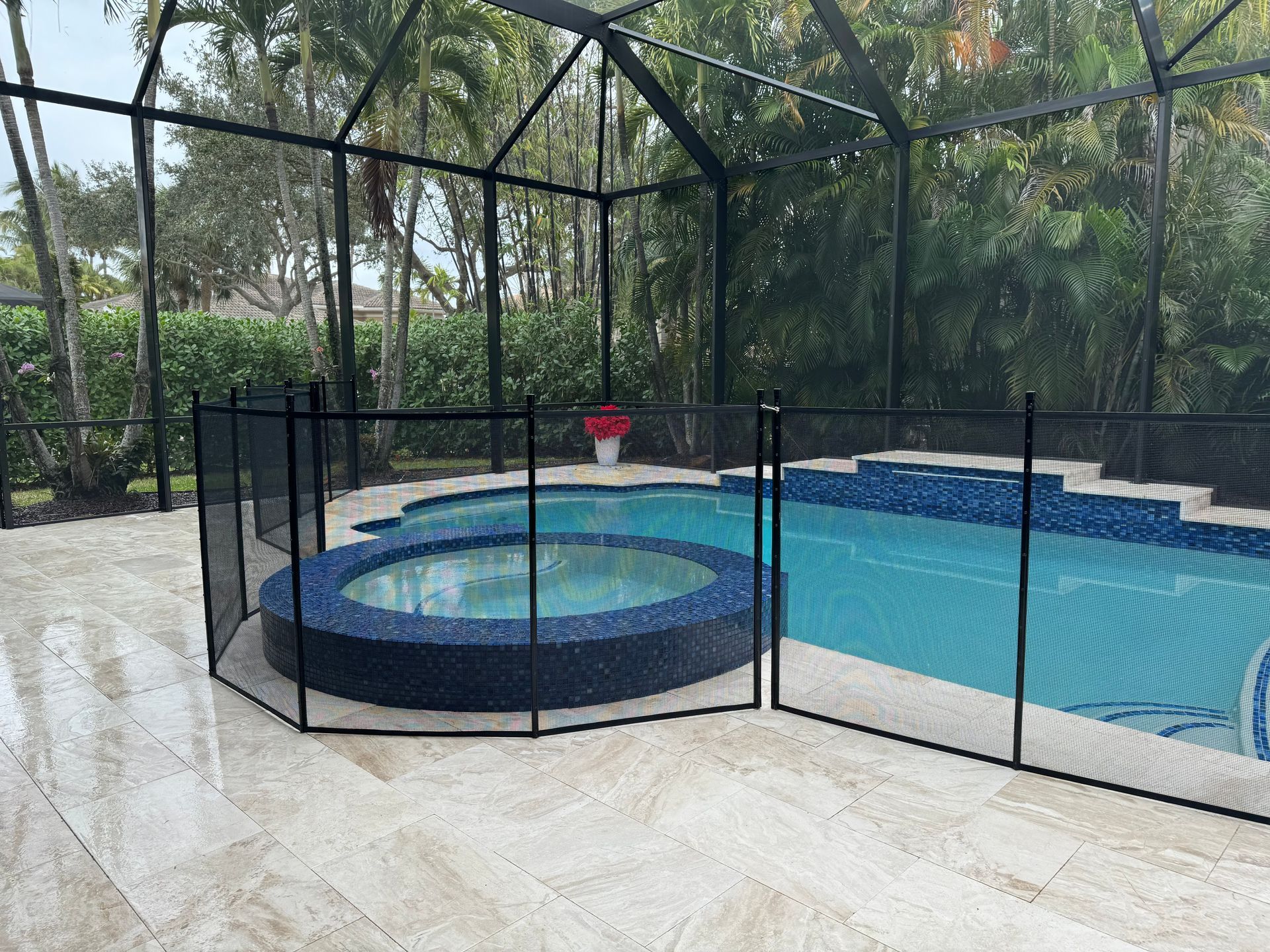 a swimming pool with a fence around it and a hot tub .