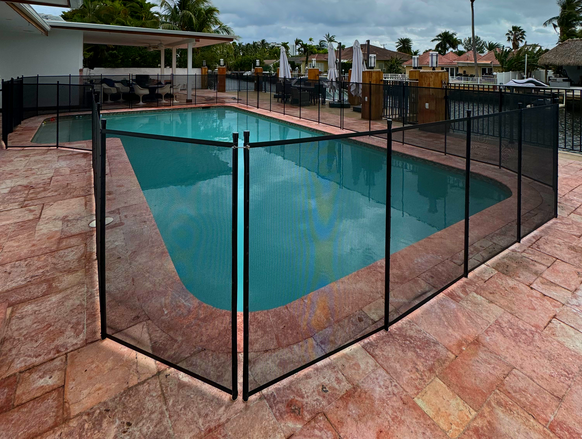 a large swimming pool with a fence around it