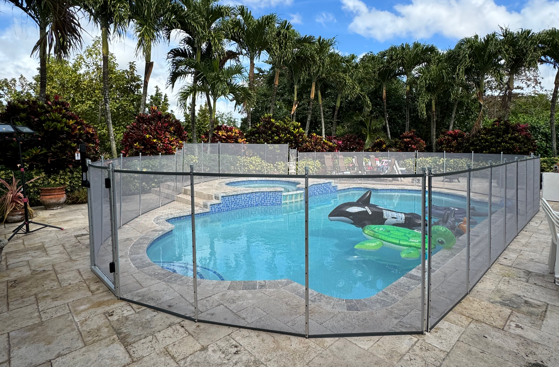 a large swimming pool with a fence around it