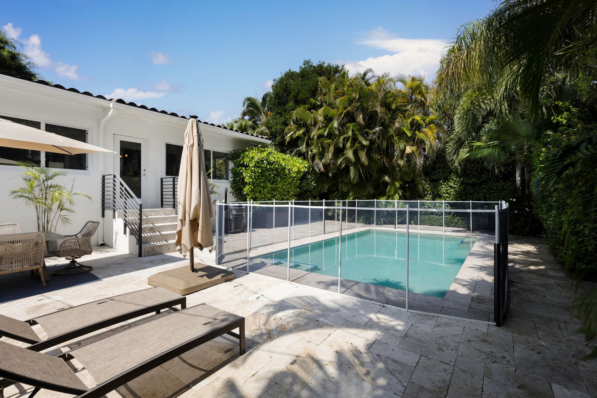 a large swimming pool in the backyard of a house