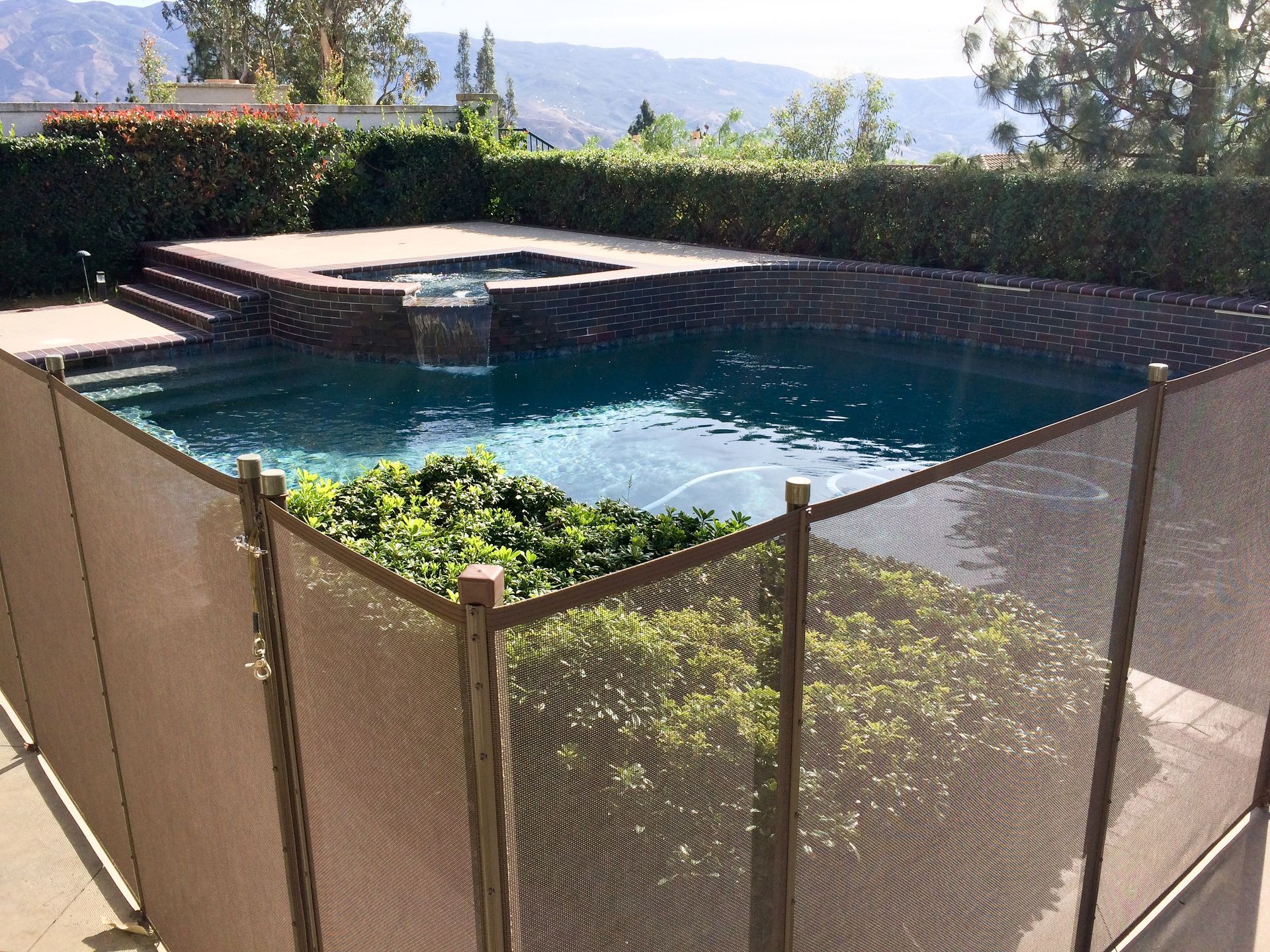 A large swimming pool with a fence around it.