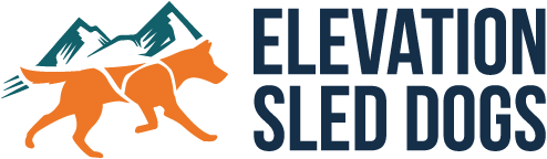 Orange dog logo with mountains beside the words “Elevation Sled Dogs”