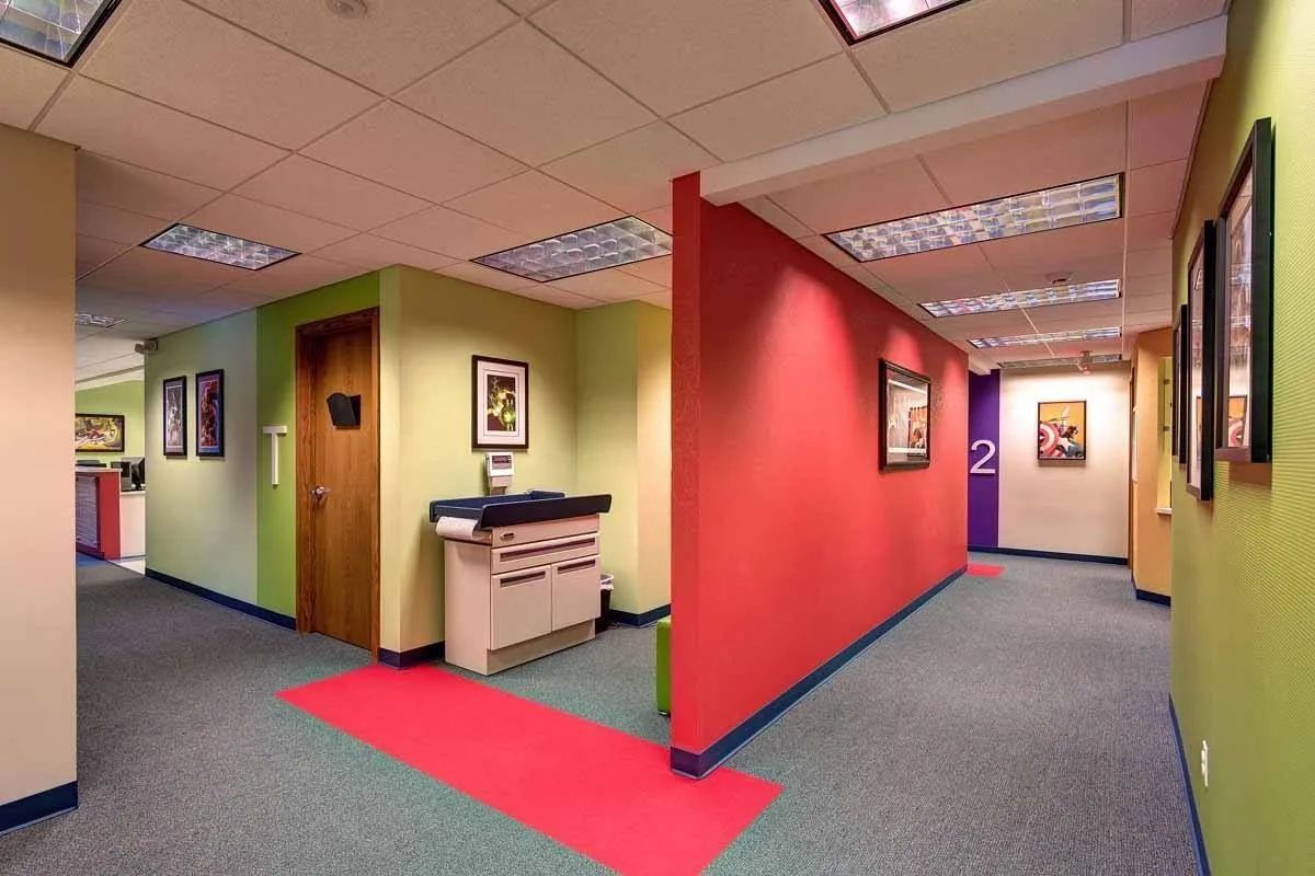 A hallway with red walls and a red carpet