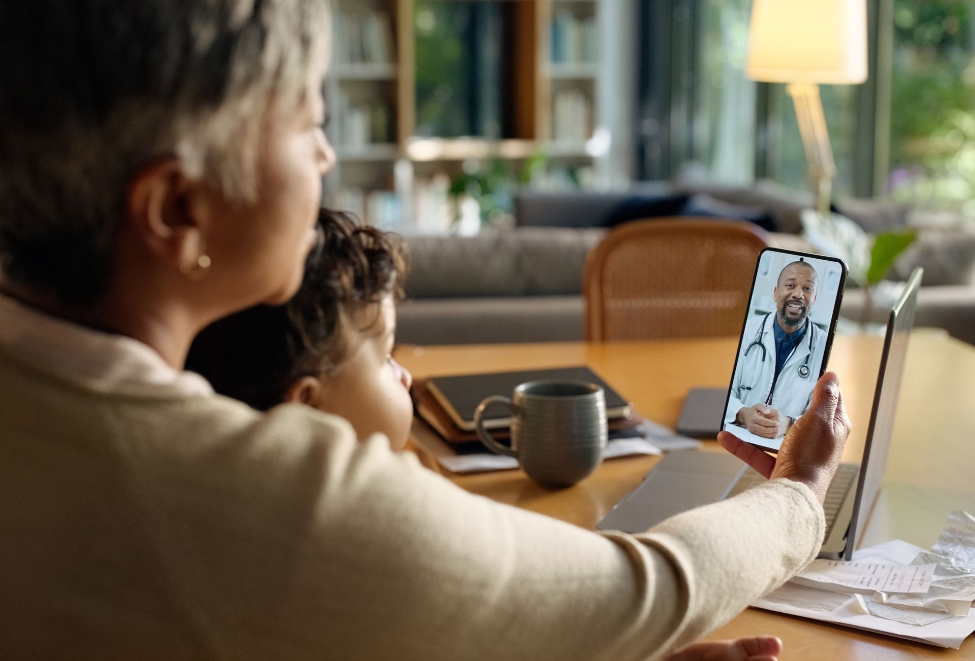 Mother and young son facetiming a doctor.