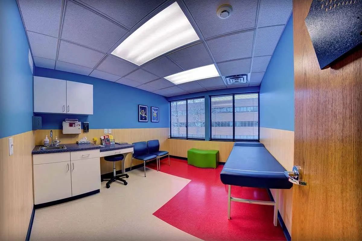 A doctor 's office with blue walls and red floors