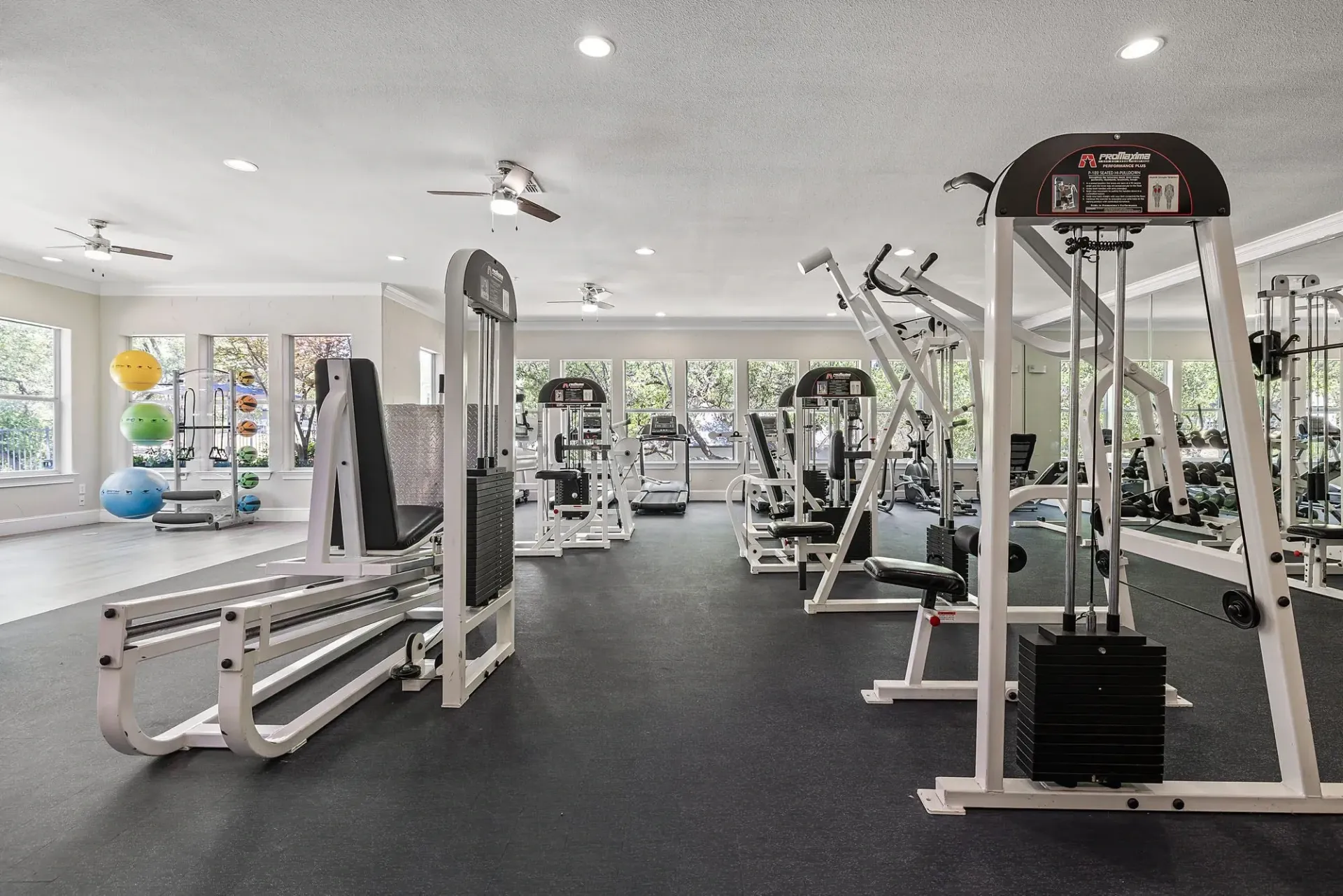 Modern fitness center with weight machines and cardio equipment.