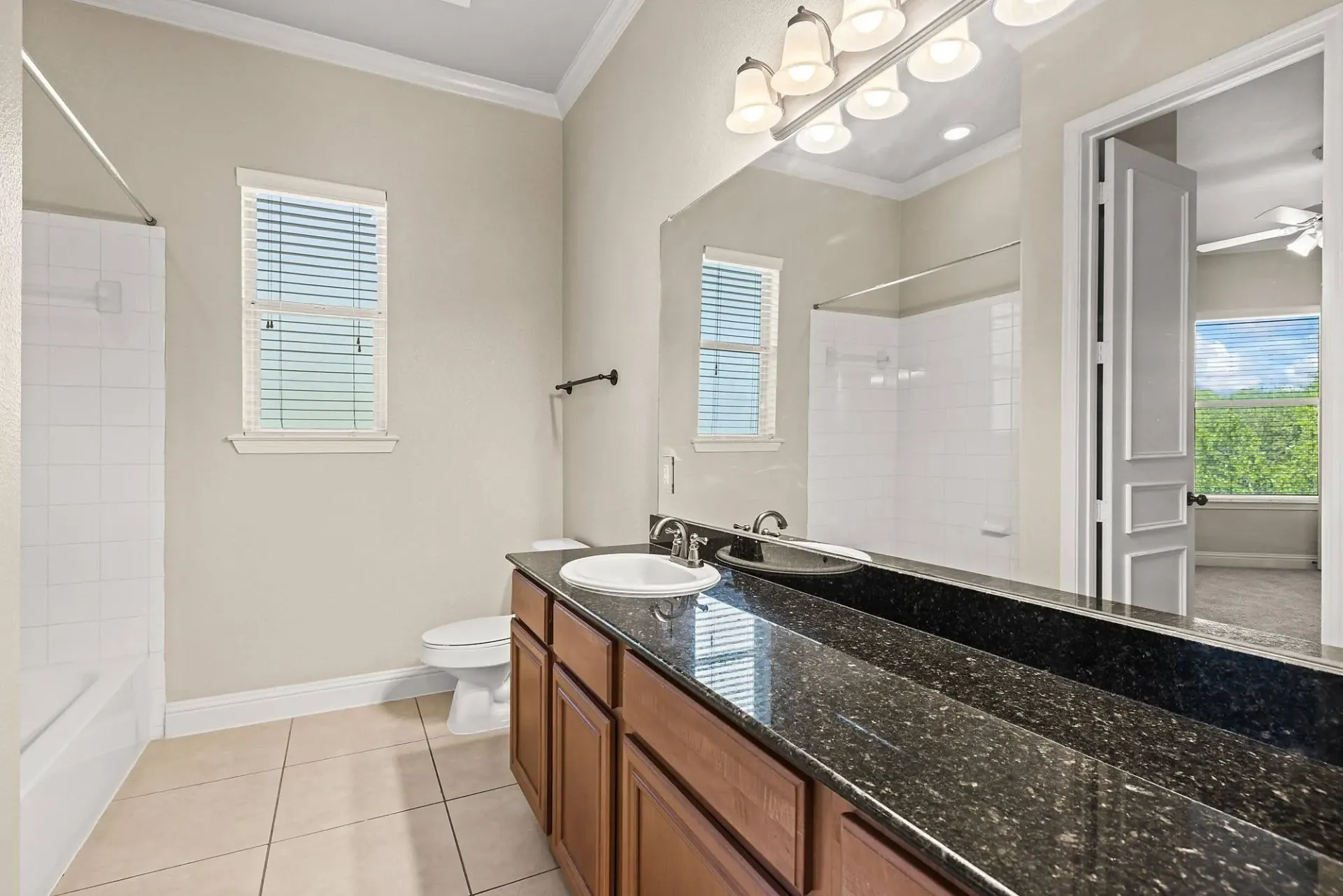 Bathroom with a double vanity, toilet, and bathtub.