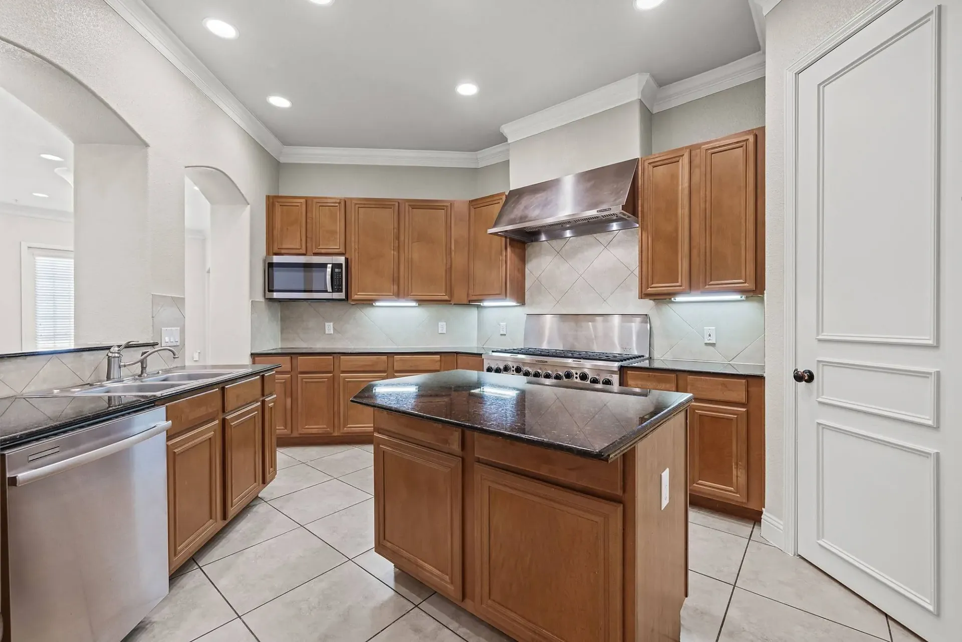 Gourmet kitchen with granite countertops, stainless steel appliances, and a large island.