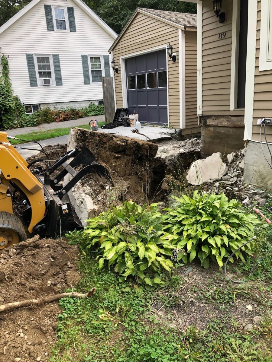 Using an excavator for residential concrete removal in Maine