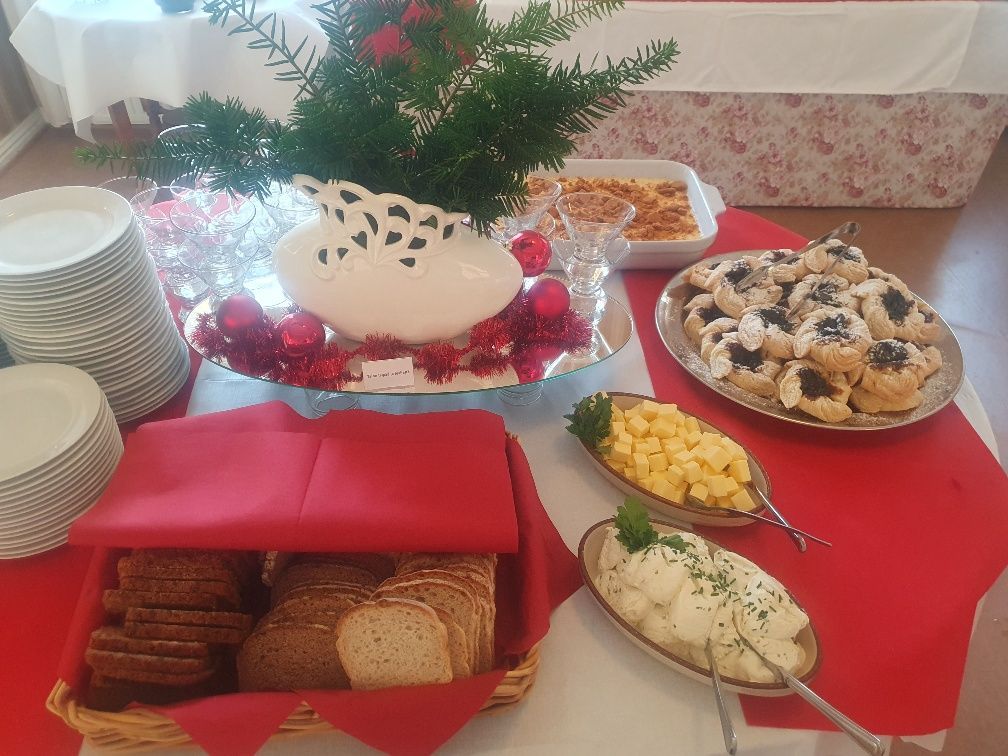A table with plates of food and a cake on it