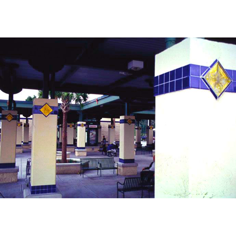 A row of columns with blue and yellow tiles on them