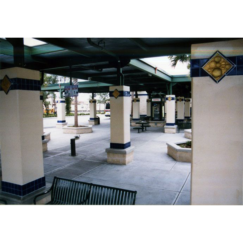 A park with columns and a bench in the middle