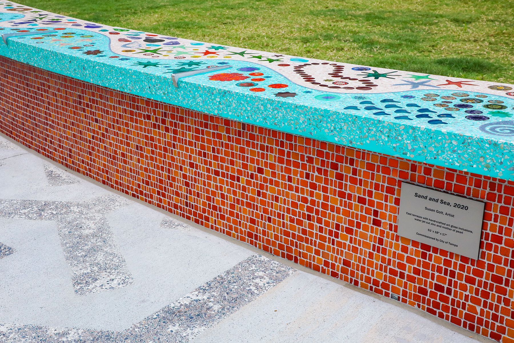 A brick wall with a sign on it that says ' memorial '