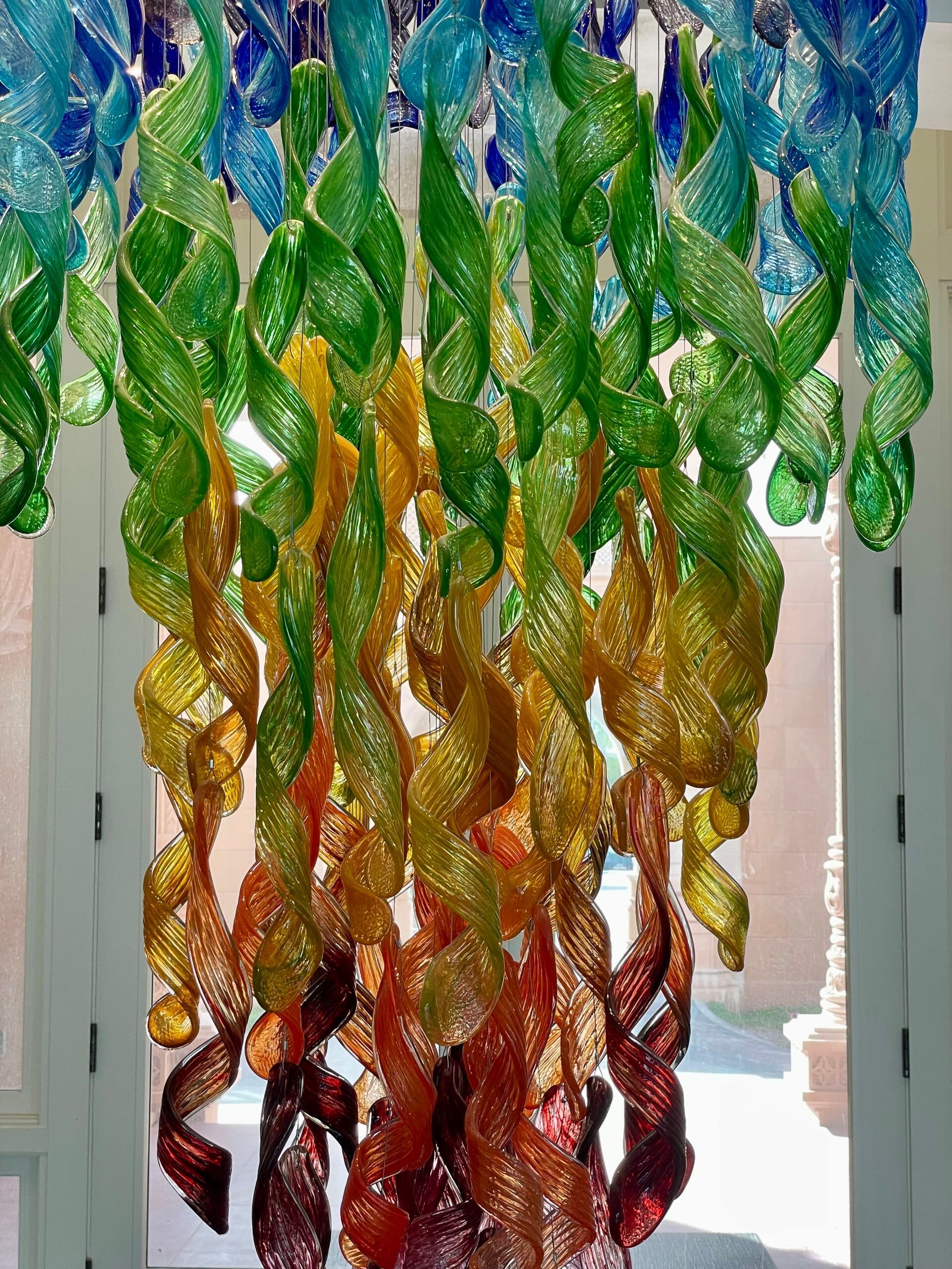 A bunch of colorful leaves are hanging from the ceiling.