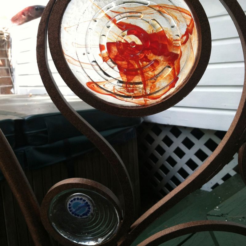 A close up of a glass sculpture with a blue sticker on it