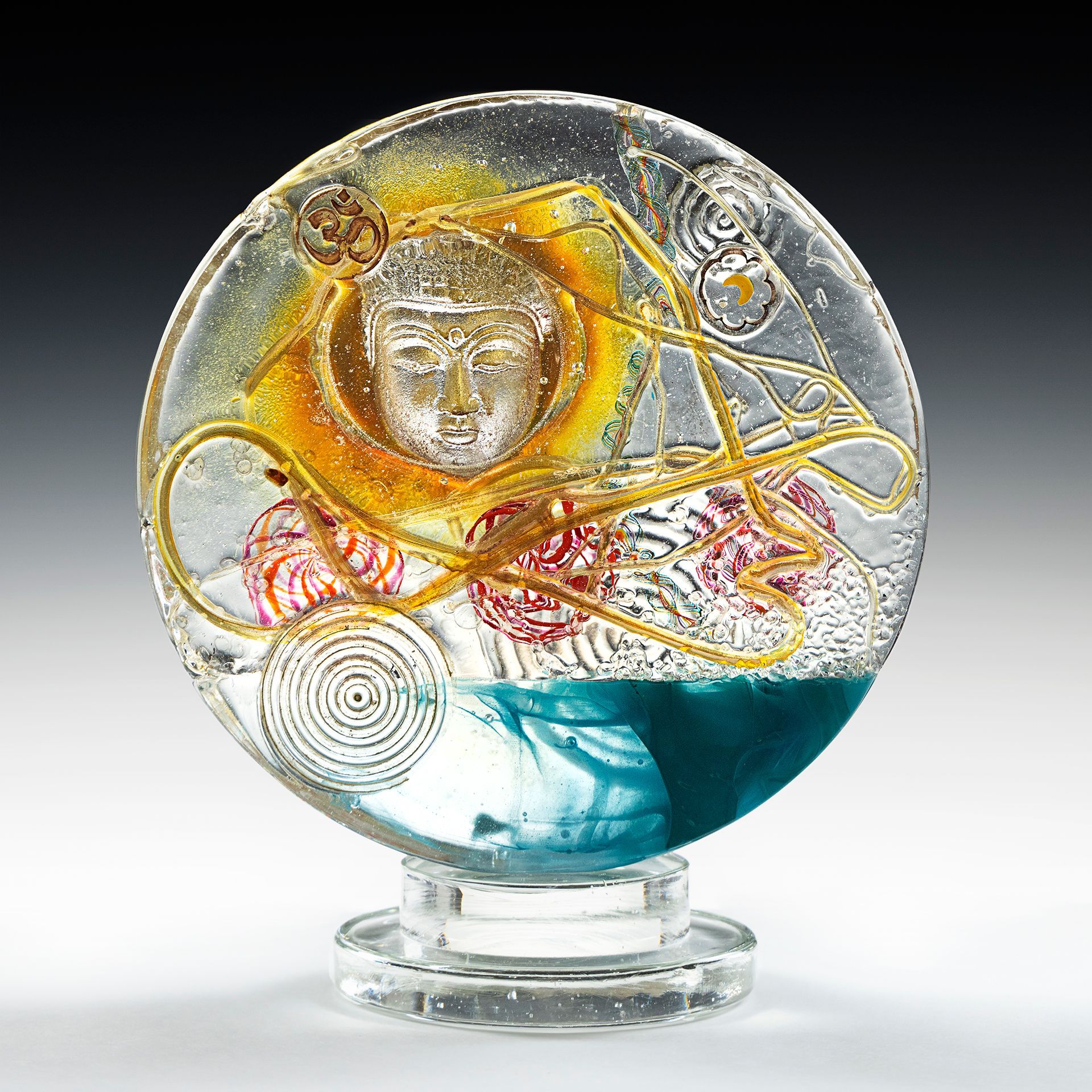 A glass sculpture with a face on it