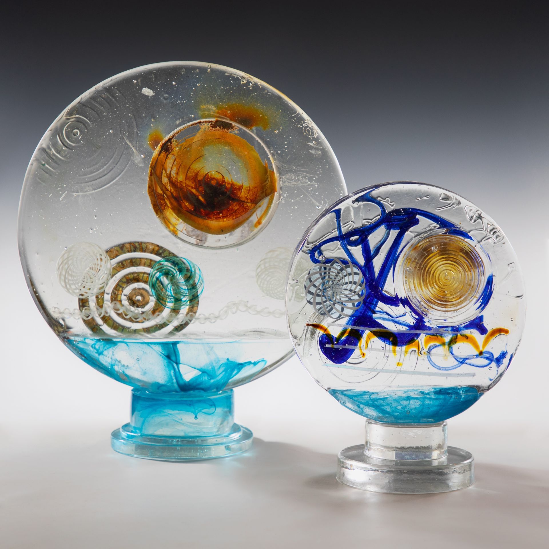 Two clear glass spheres with different designs on them