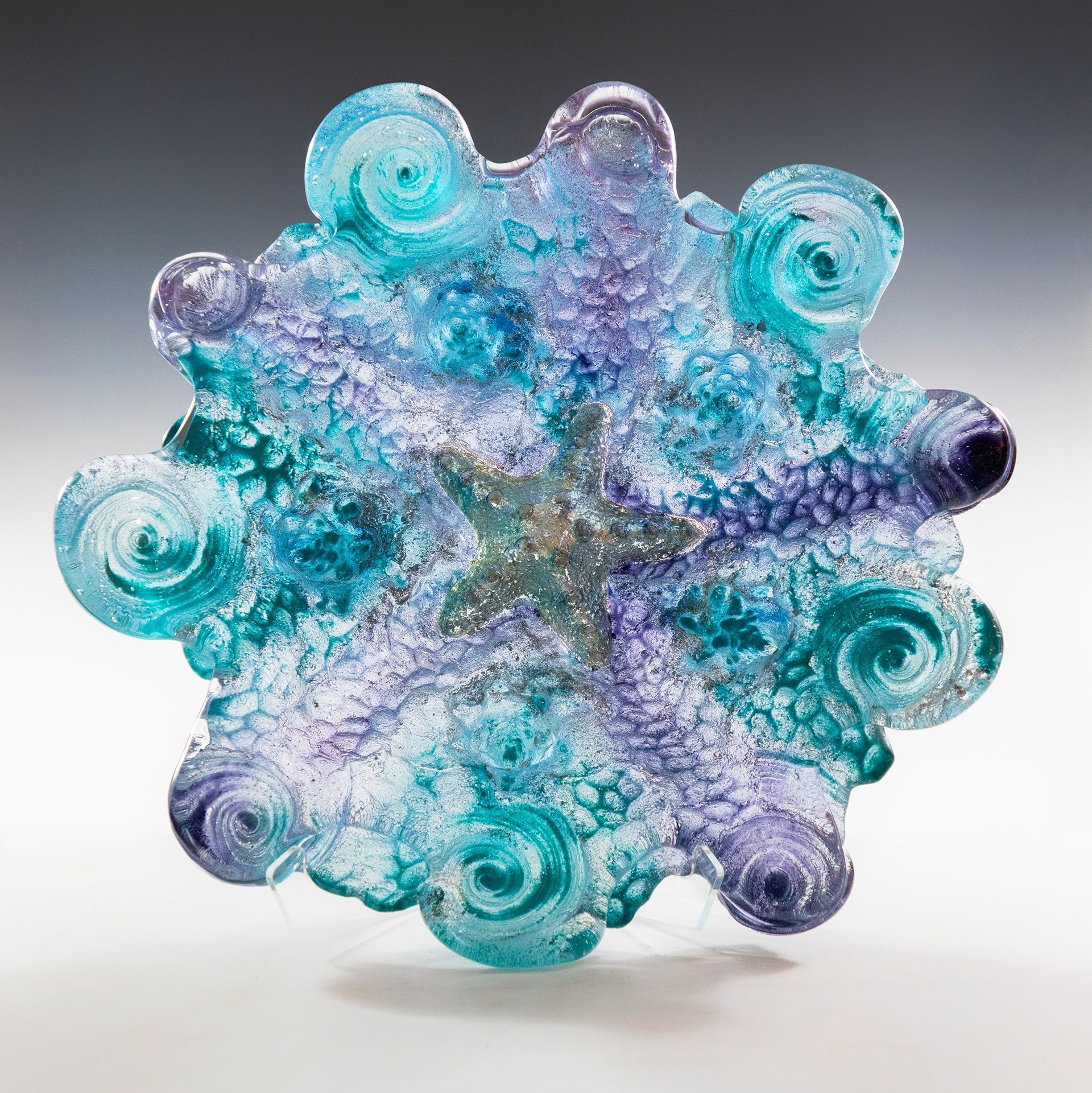 A blue and purple glass sculpture of a starfish