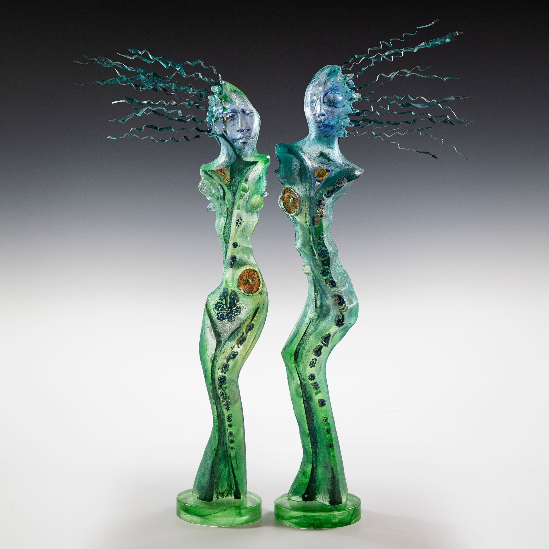 Two sculptures of a man and a woman are standing next to each other