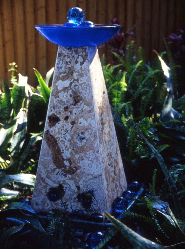 A pyramid with a blue bowl on top of it