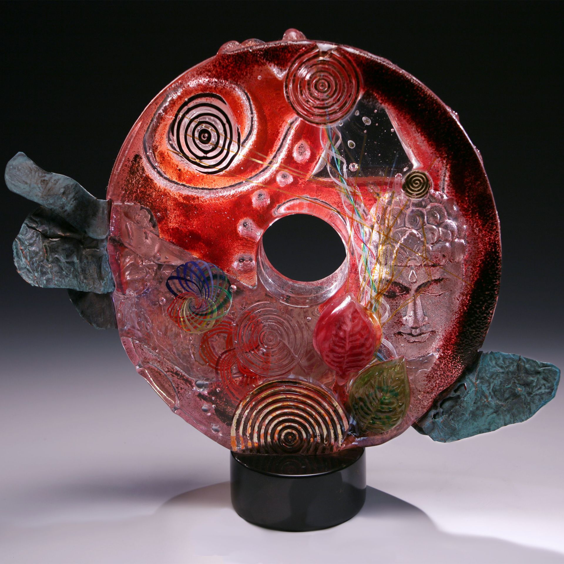 A sculpture of a circle with a face on it