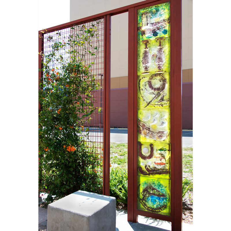 A fence with a stained glass panel that says peace
