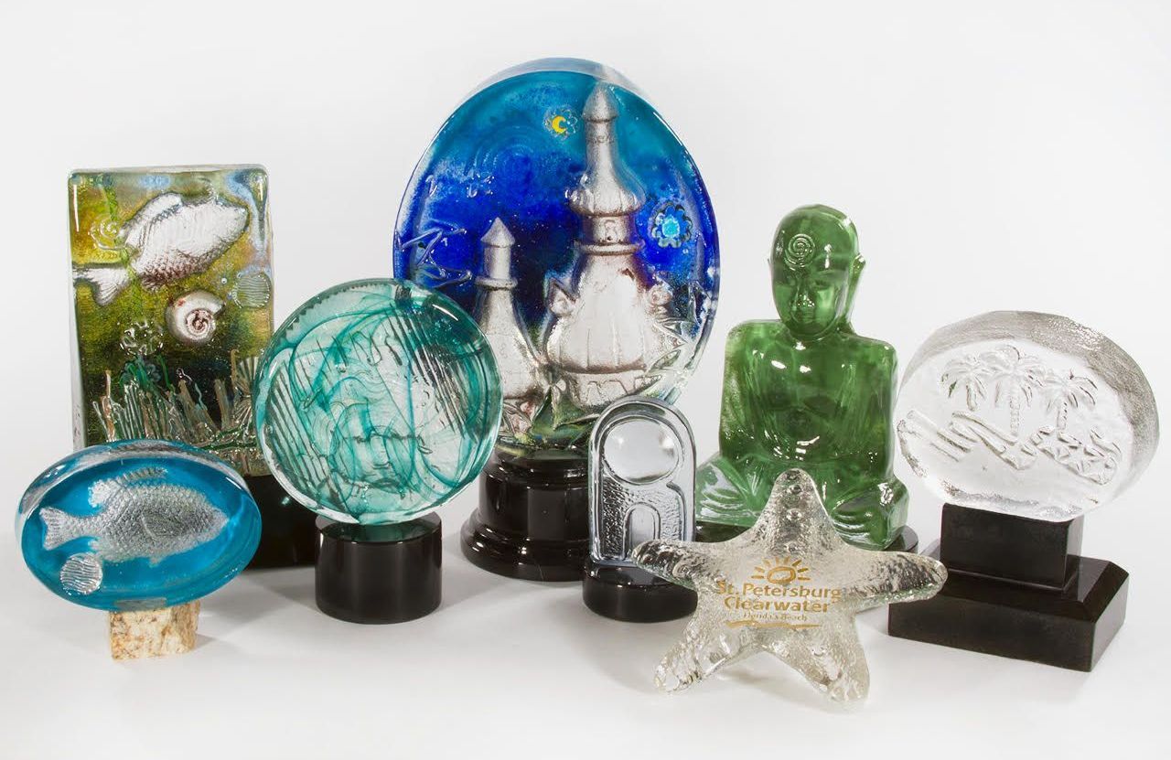 A group of glass sculptures are sitting on top of each other on a table.