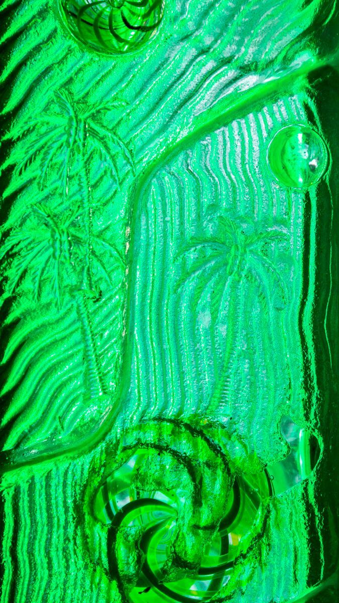 A close up of a green painting with a swirl on it.
