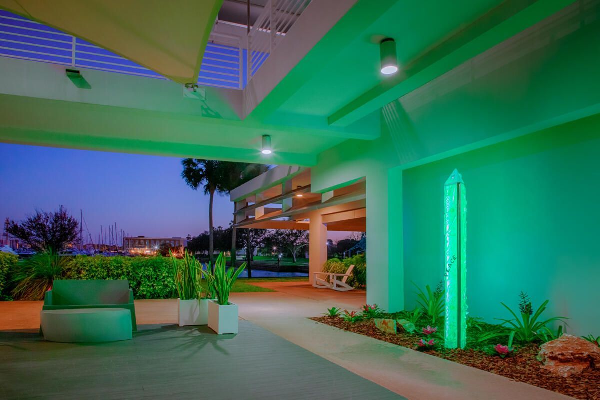 A green building with a surfboard on the side of it.