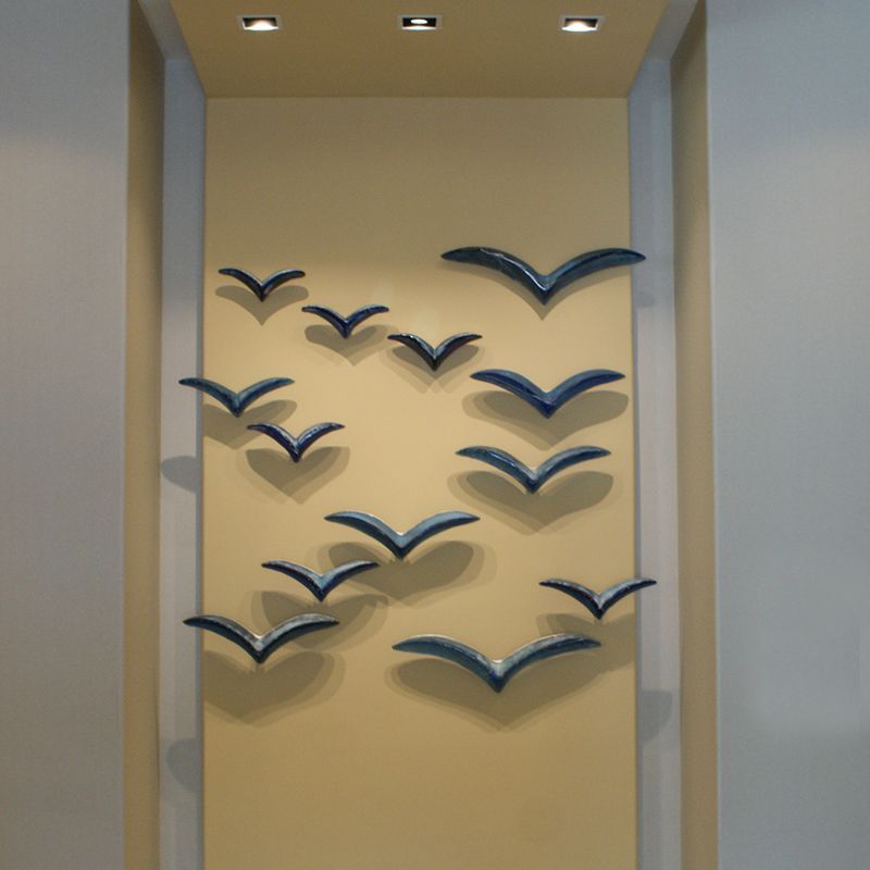 A wall with a bunch of birds on it